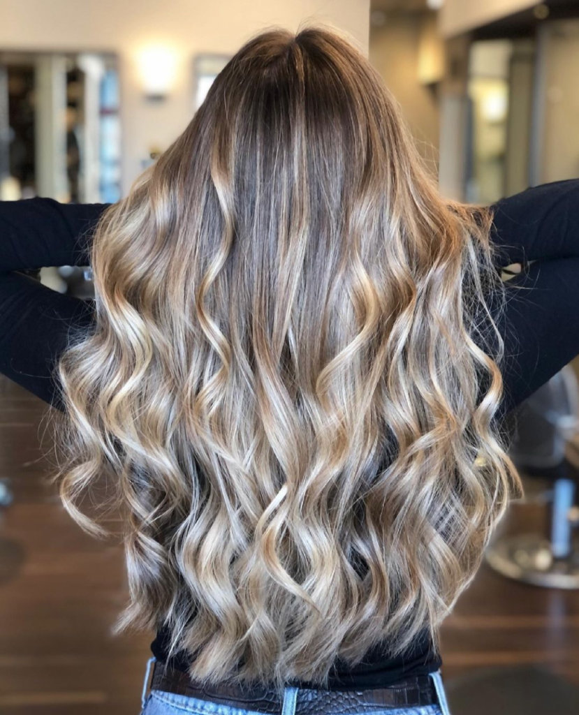 Portfolio photo of a long wavy blonde balayage performed by a stylist at Elle Marie Hair Studio